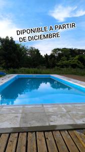 a blue swimming pool with the words promote a particular be difference at Refugio del Monte in Veronica