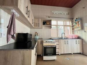 a kitchen with a stove and a sink at Kinigi Holiday Home in Kinigi +15 photos