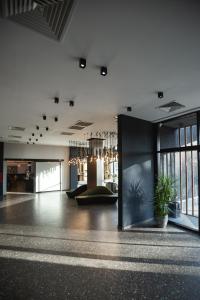a large room with a lobby with a couch and windows at The West Inn-Georgia Hotel in Kutaisi +57 photos