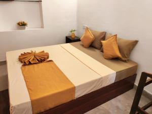 a bed with pillows and a box on it at Eco Bliss in Ahangama