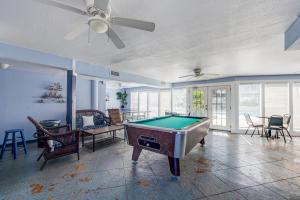 a living room with a pool table in it at Beach Bum Headquarters in Mustang Beach