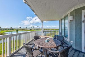 a patio with a table and chairs on a balcony at Beach Bum Headquarters in Mustang Beach