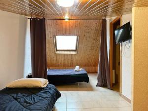 a room with two beds and a television in it at Apartamentos Solaris 3000 in Pas de la Casa