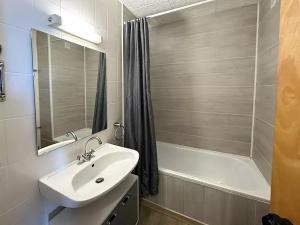 a bathroom with a sink and a bath tub at Apartamentos Solaris 3000 in Pas de la Casa