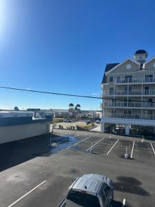 a parking lot with a car parked in front of a building at Aqua Amour Studio in Old Orchard Beach