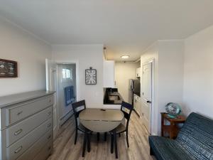 a small kitchen with a table and chairs in a room at Aqua Amour Studio in Old Orchard Beach