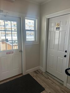 an empty room with two doors and a window at Aqua Amour Studio in Old Orchard Beach
