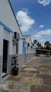 Vila do Walbinho في باريرينهاس: صف من المباني مع نبات في وعاء على الرصيف