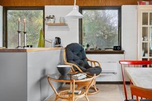 a living room with a chair and a table at LF18112-Veslos-Jegindovej-12 in Amtoft +11 photos
