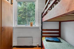 a bedroom with a bunk bed and a window at LF18112-Veslos-Jegindovej-12 in Amtoft