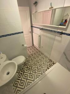 a bathroom with a toilet and a sink at Polmear Harbour View With Terrace in Looe +20 photos