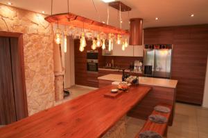 a kitchen with a wooden counter top in a room at VILLA BEELVITA - PRIVATE POOL& JACUZZi in Bielovce