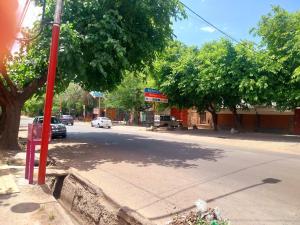 a red pole on the side of a street at La casa de las flores in Las Heras
