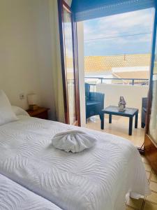 a bedroom with a bed with a view of a balcony at Casa Joan de l'Illa in Deltebre +21 photos