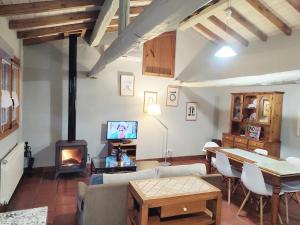 a living room with a couch and a fireplace at La Herrera lll in San Esteban de la Sierra
