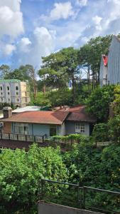 a house with a red roof in a city at Burnham Hill 504 Baguio Condo by Dei Gratia in Baguio