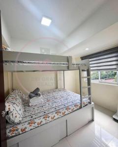 a bedroom with a bunk bed in a room at Burnham Hill 504 Baguio Condo by Dei Gratia in Baguio