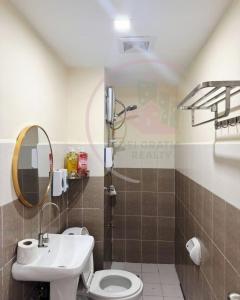 a bathroom with a toilet and a sink at Burnham Hill 504 Baguio Condo by Dei Gratia in Baguio +18 photos