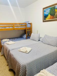 two beds sitting next to each other in a room at Casa Joan de l'Illa in Deltebre