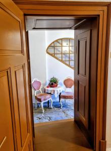 a door leading into a dining room with a table and chairs at Apartment in a historical house in the center of Levoča in Levoča