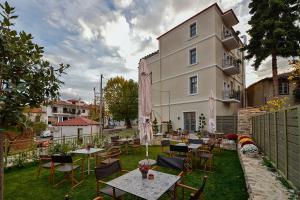 a patio with tables and chairs in front of a building at Megaro Gioule in Siatista +24 photos