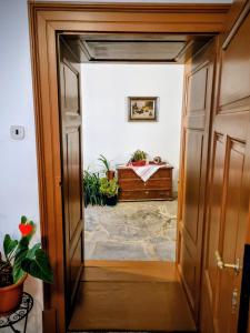 an open door leading into a room with plants at Apartment in a historical house in the center of Levoča in Levoča +57 photos