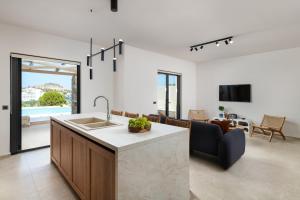 a kitchen and living room with a couch and a table at Villa Celestia in vlicha