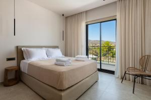 a bedroom with a large bed and a balcony at Villa Celestia in vlicha +27 photos