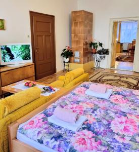 a living room with a large table with a flower pattern at Apartment in a historical house in the center of Levoča in Levoča