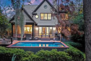 a house with a swimming pool in front of it at SS162: 162 Surfsong Road in Kiawah Island
