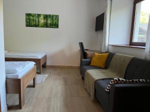 a living room with a couch and a table at Erdőhangja Vendégház in Mikóháza