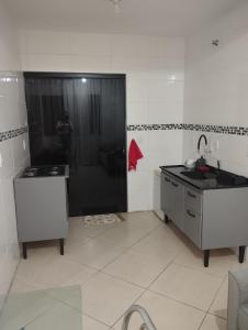 a kitchen with a sink and a shower in it at Sobrado Harmonia in Ponta Grossa