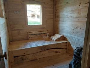 a wooden sauna with a bench in a cabin at Cicha Strzała 