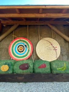 a table with two hats and some green objects at Cicha Strzała  +15 photos