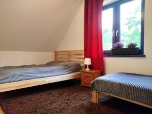 a bedroom with two beds and a window at Malëna Mausz in Parchowo