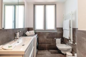 a bathroom with a sink and a toilet at Residenza di Luce - by MyHomeInComo in Griante Cadenabbia +34 photos