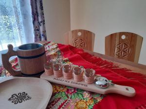 a table with a tray with cups on it at Domki nad Borem in Małe Ciche