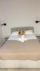 a large white bed in a white room with at Apartamenty Dąbrówka Beauty - w parku leśnym , sauna in Jelenia Góra