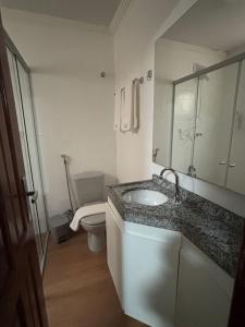 a bathroom with a sink and a toilet at 44 Residence in Belém