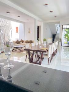 a dining room and living room with a table and chairs at Trident Kandy in Kandy