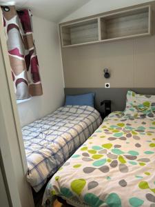 ein kleines Schlafzimmer mit einem Bett und einem Fenster in der Unterkunft mobil home in La Tremblade + 1 Foto