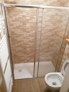 a shower stall in a bathroom with a toilet at Appartamenti Pila Vacanze 2 in Cerise +23 photos