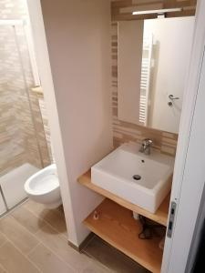 a bathroom with a sink and a toilet at Appartamenti Pila Vacanze 2 in Cerise