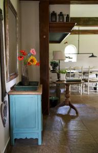 a room with a table with a vase of flowers on it at De Fazant in Laren +17 photos