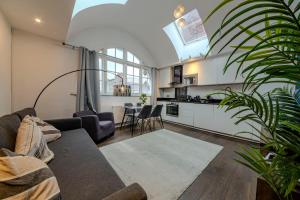 a living room with a couch and a kitchen at Berwick Soho Suites by Aureva Residences in London +125 photos