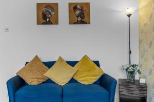 a blue couch with pillows on it in a living room at Greenview in Spinney Hill