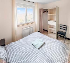 a bedroom with a bed and a chair and a window at Marluis Mer - Apartment near dunes and beach in Cucq