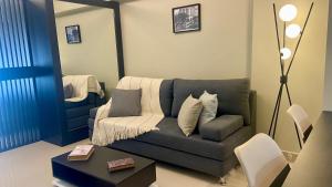 a living room with a couch and a mirror at Casco Histórico Apart I in Buenos Aires