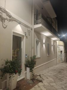 a building with two potted plants and a balcony at HT Room Spa & Suite in Brindisi