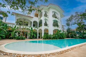 a house with a swimming pool in front of it at Oura Spirit in Unawatuna